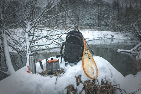 A picnic on a fishing trip, on a snow-covered winter river.の写真素材