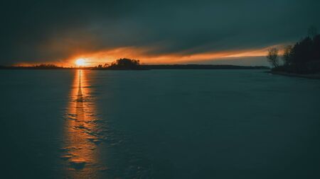Silhouette of a man on a frozen lake.の写真素材