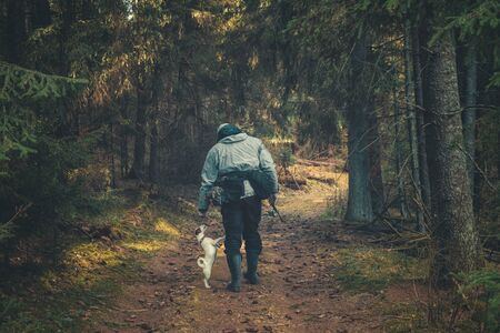 The dog with the owner going on a fishing trip.の写真素材