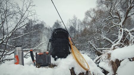 A picnic on a fishing trip, on a snow-covered winter river.の写真素材