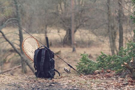 Fishing equipment close-up on the riverbank.の写真素材