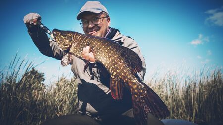 Fish in angler hand.の写真素材
