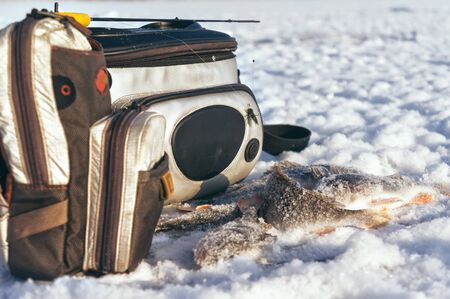 Fishing tackle on the background of ice and snow. Winter fishing.の写真素材