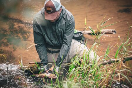 The fisherman caught a beautiful trout.の写真素材