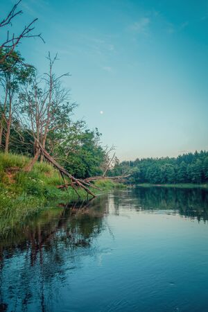 Moon over the evening river