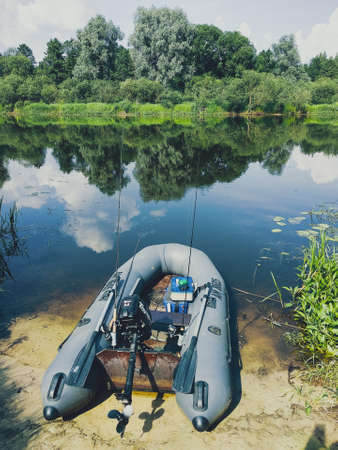 River Berezina. Belarus - June 12, 2019: Fishing inflatable boat with fishing gear. Motor brand Toyama.のeditorial素材