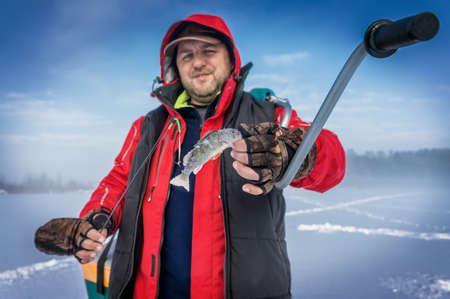 Fisherman caught perch ice fishing.の写真素材