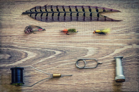 Fishing accessories on a background of woodの写真素材