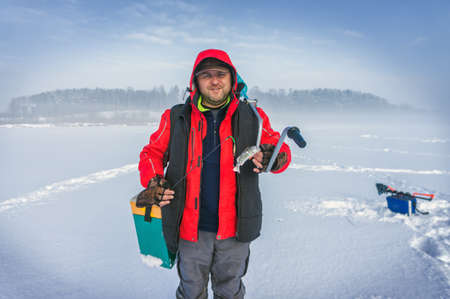 Fisherman caught perch ice fishing.の写真素材