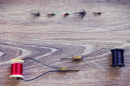 Fishing accessories on a background of woodの写真素材