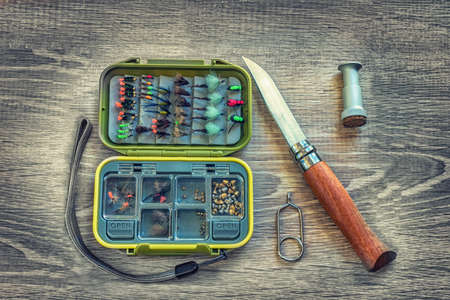 Fishing accessories on a background of woodの写真素材