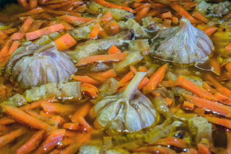 Garlic and cook a carrot in a dish.の写真素材