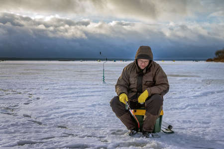 Fisherman on ice fishingの写真素材