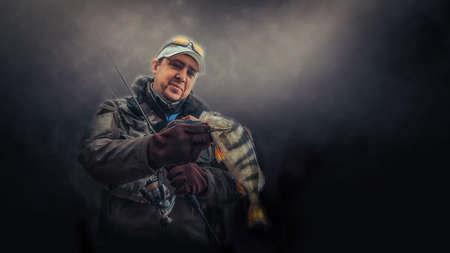Fishing. Happy angler with fish.の写真素材