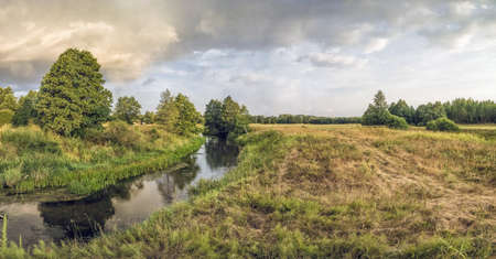 Spring river flowing in a valley.の写真素材