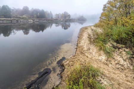 Coast of the autumn river in a fog. Stitched Panoramaの写真素材