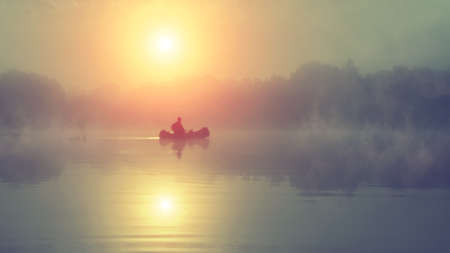 Fishing. A misty morning in a boat.の写真素材