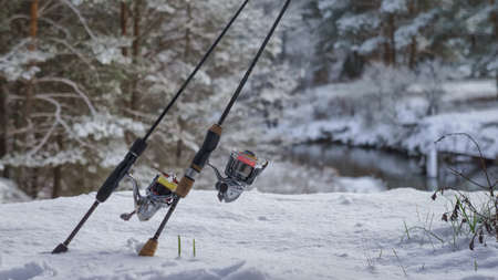 Fishing gear on a winter, snow-covered river.の写真素材