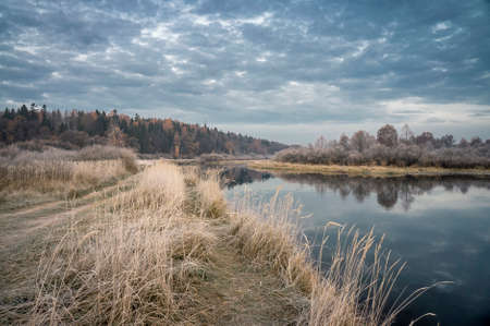 Autumn Field in frost. Dawn. River.の写真素材