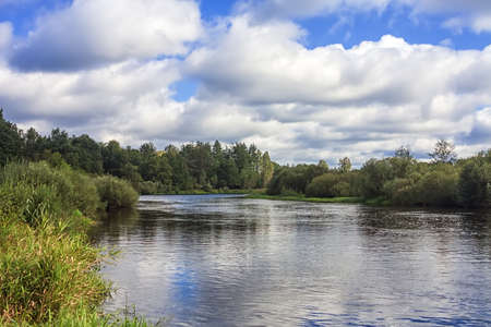 Clouds over the river in the forest valley.の写真素材