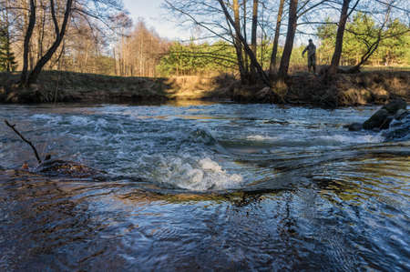 Spring river flowing in a valley.の写真素材