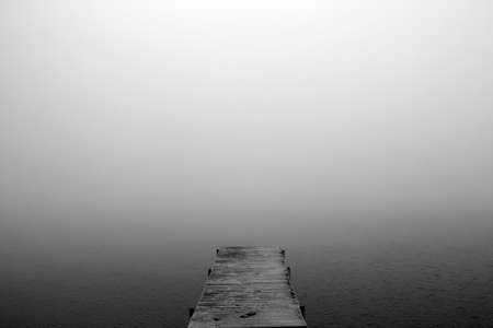 The bridge stretching into the misty lakeの写真素材