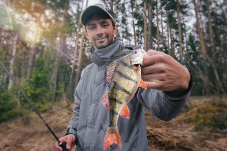Fisherman with perch.の写真素材