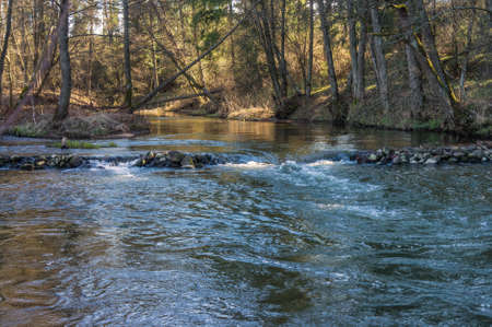 Spring river flowing in a valley.の写真素材