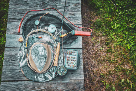 Fishing equipment. A rod, a box of flies and a hat.の写真素材
