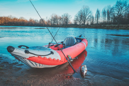 Fishing from a kayak on the autumn river.の写真素材