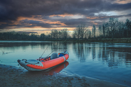 Fishing from a kayak on the autumn river.の写真素材