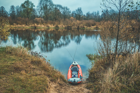 Fishing from a kayak on the autumn river.