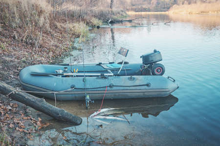 Inflatable fishing boat on the river bank.の写真素材