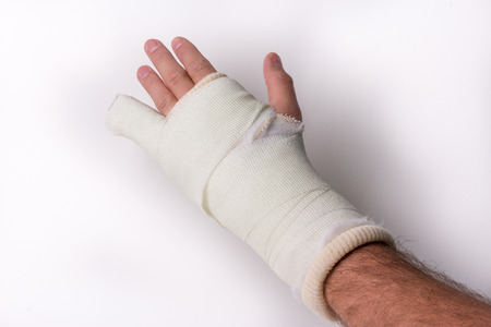 Little finger Arm Wrist in cast on a white background, studio isolatedの写真素材