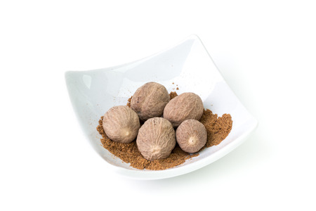 Bowl of nutmeg on a white background, studio isolatedの写真素材
