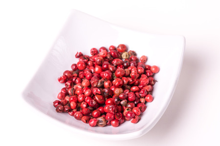 Pink peppercorn on a white background, studio isolated