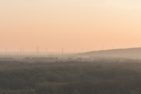 windmill park in nature, renewable energy park at sunset