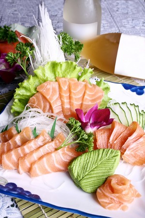 vegetables around salmon sashimiの写真素材