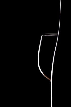 empty glass and winebottle on black backgroundの写真素材