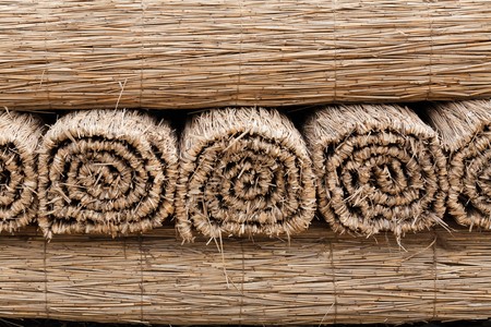 Stack of grass mat in fieldの写真素材