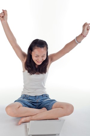 Young woman using a computer and smilingの写真素材