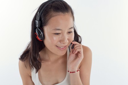 Young woman listening and smilingの写真素材