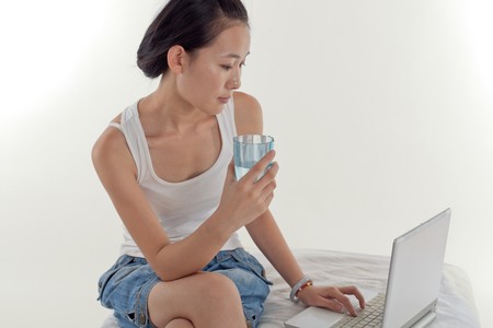 Young woman play her laptop computerの写真素材