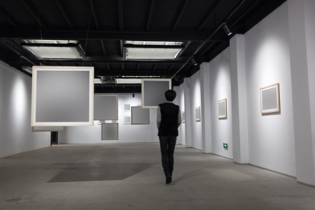 art gallery, girl look at the blank frameの写真素材