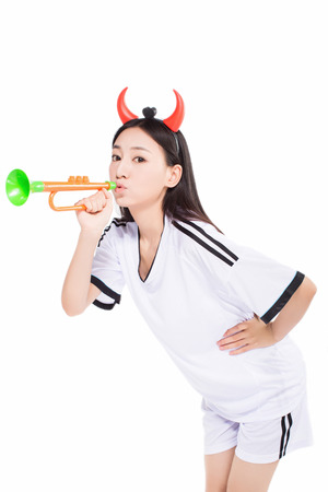 uniformed cheerleader a pose with a megaphone isolated on white.の写真素材