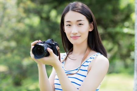 asian woman with cameraの写真素材