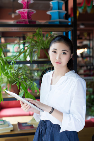 Young women using a tablet in a cafeの写真素材