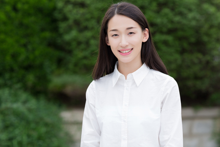 young female student with smiley faceの写真素材