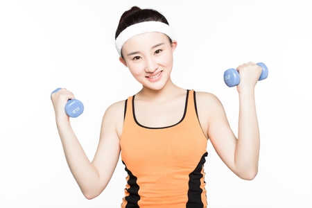 woman working out with dumbbells happy and healthy lifestyle isolated on white backgroundの写真素材