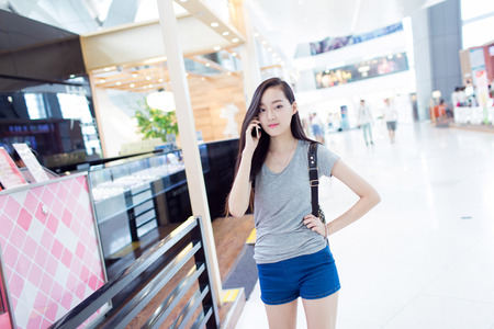 chinese girl, carrying a backpack in a shopping centerの写真素材